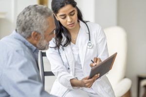 Woman Doctor with Patient in Consultation