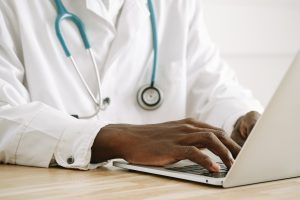 Doctor Writing on Laptop