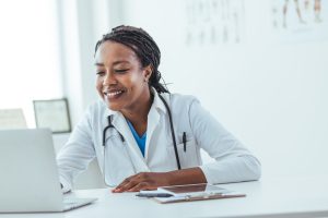 Doctor Using Laptop on Office