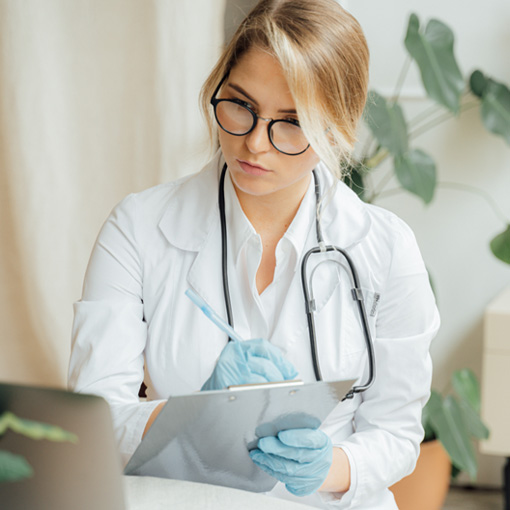Doctor Taking Notes On Her Computer