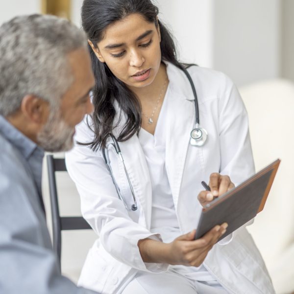Woman Doctor with Patient in Consultation